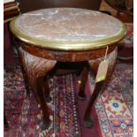 A pair of marble topped oval low tables with brass bound edges on mahogany carved cabriole supports.