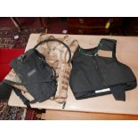 A stab vest together with a heavy duty water carrier and army vest
