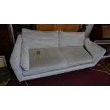 A large twin seater sofa by Laura Ashley upholstered in cream velvet with matching cushions, on four