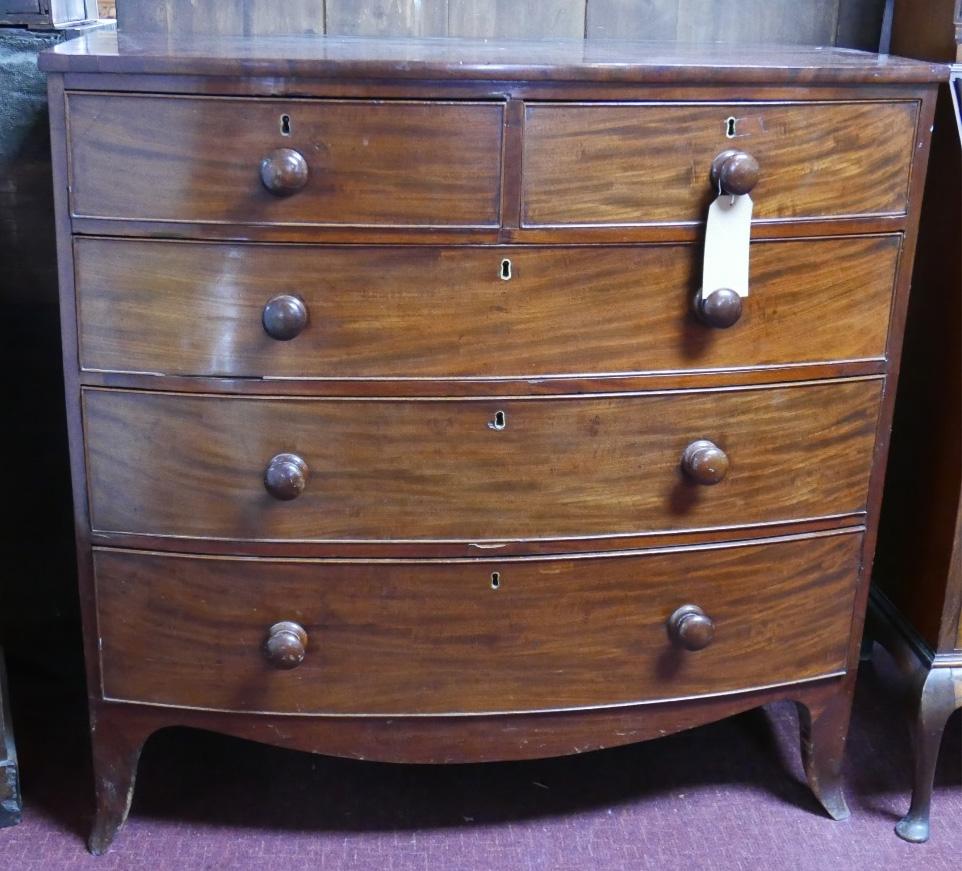 A Georgian mahogany bowfronted chest of two short over three long oak lined drawers on swept feet,