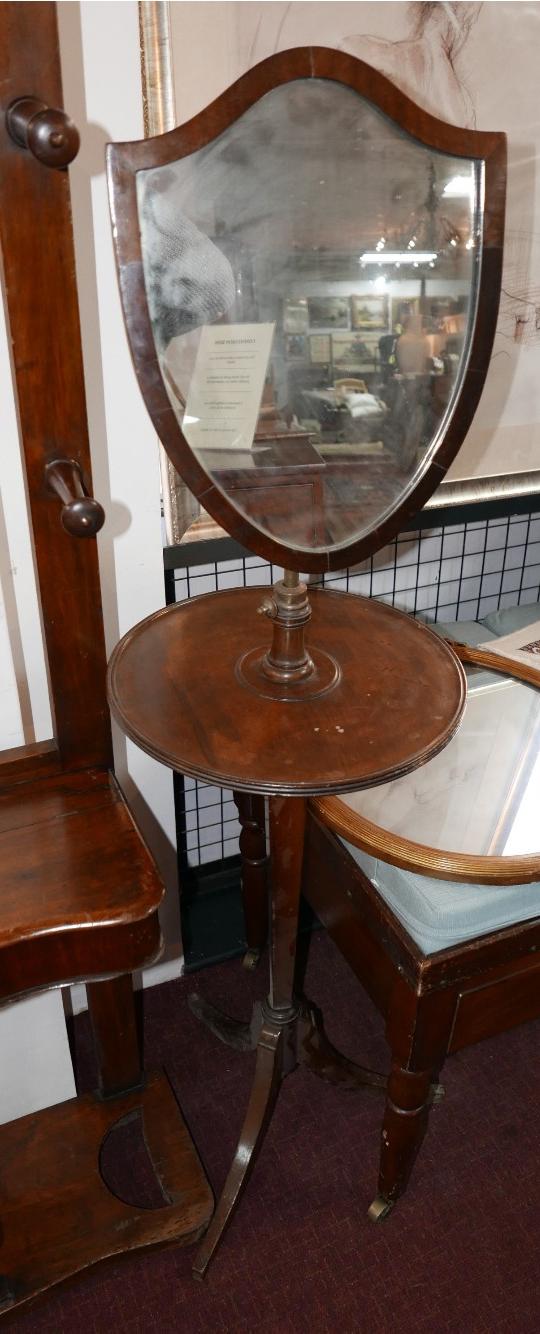 An Edwardian mahogany adjustable mirrored shaving stand on tripod base.