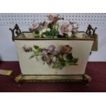 A gilt metal and porcelain jardiniere with faux floral display. H.43 W.53cm