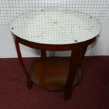 An Art Deco two tiered circular occasional table, the mirrored top etched with martin glasses and