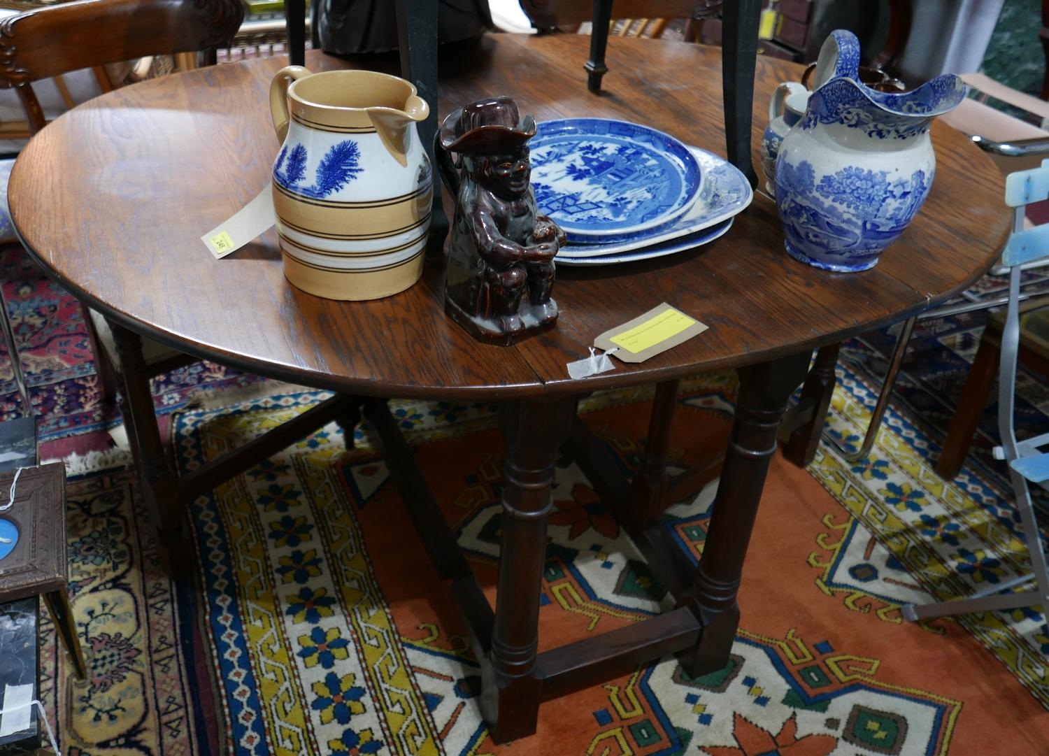 An antique style oak drop flap dining table, H.75 W.123cm