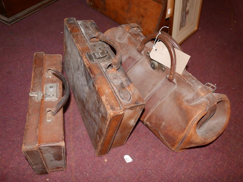 Two small vintage leather cases together with a vintage leather Gladstone bag