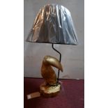 A gilt toucan table lamp, with black shade, on naturalistic base, H.80cm