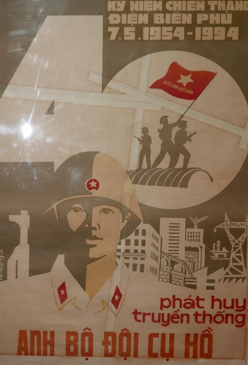 A framed and glazed Vietnamese military propaganda poster H.71 W.49cm