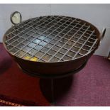 A cast metal fire pit, on stand, H.41cm Diameter 64cm