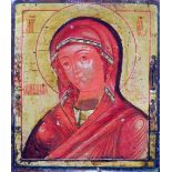 A Russian icon of a female saint, tempera on wood panel with gilt background, with velvet cover to