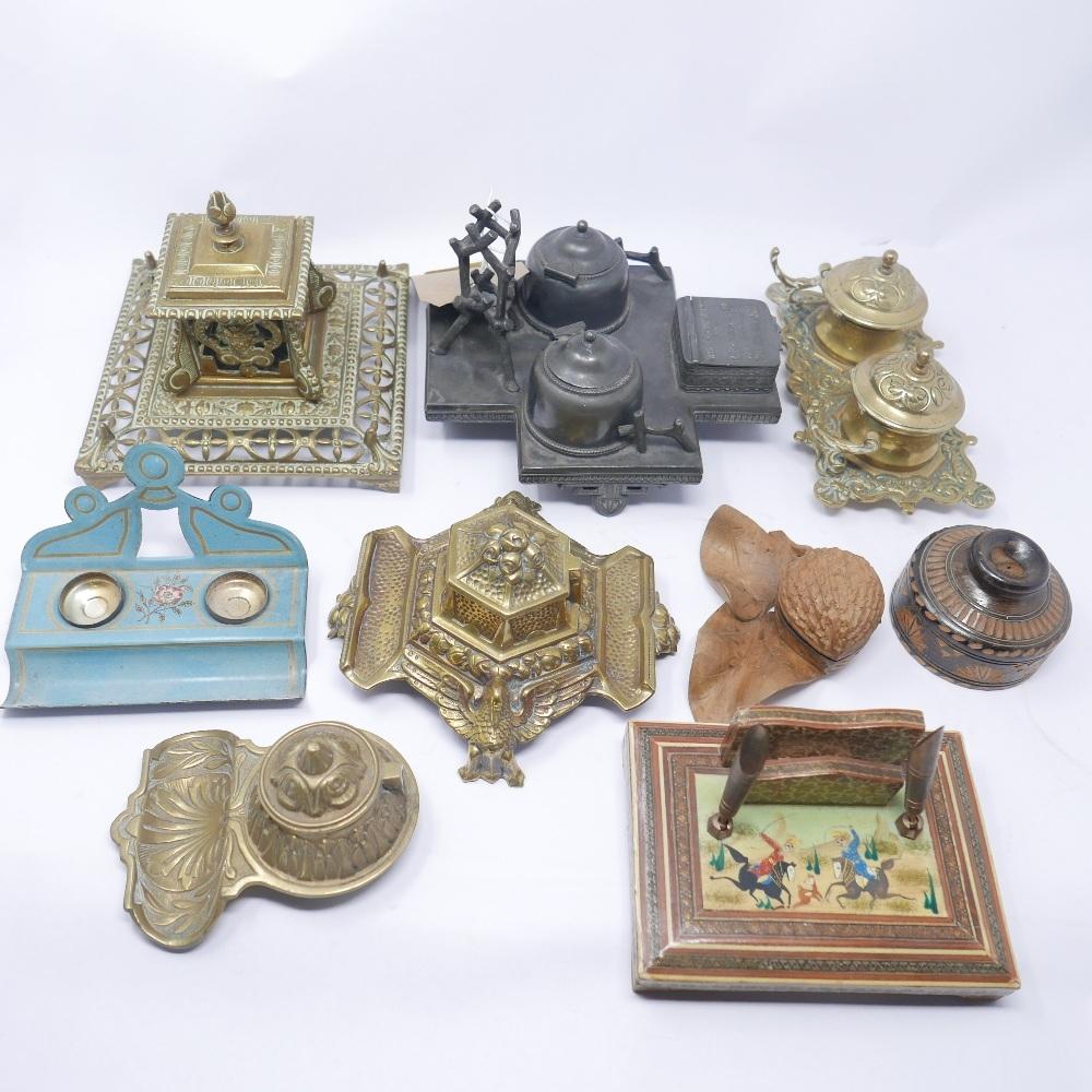 A collection of nine ink stands to include one pewter, four brass, two treen, one toleware and one