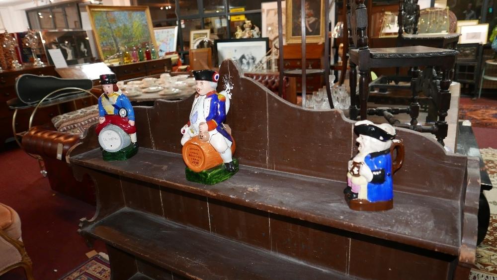 Two French caricature jugs and a smaller English Toby jug, tallest 28cm