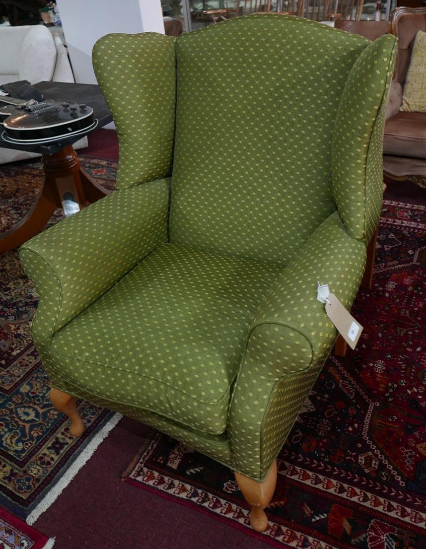 A contemporary wing back armchair in green and gold upholstery raised on beech wood legs - Image 2 of 2