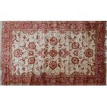 A Ziegler style rug with floral design on a beige ground, contained by floral border, 190 x 140cm