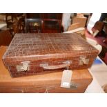 An early 20th century Army & Navy crocodile skin travelling vanity case, H.16 W.56 D.35cm