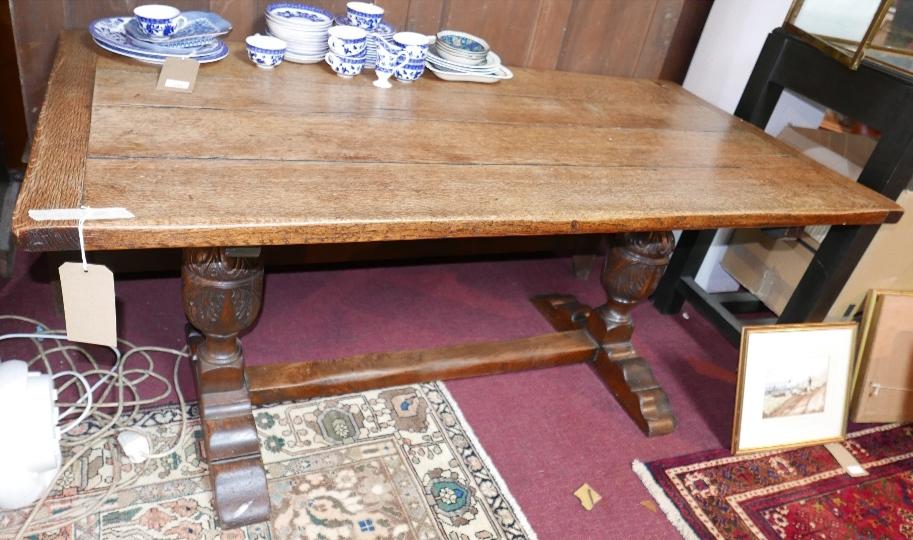 An 18th century oak refectory table, raised on earlier carved baluster supports, possibly 16th