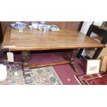 An 18th century oak refectory table, raised on earlier carved baluster supports, possibly 16th