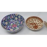 Two handpainted Chinese bowls, the larger example decorated with a profusion of coloured flowers