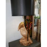 A contemporary table lamp, with a gilt a gilt composite toucan base and black drum shade, H.71cm