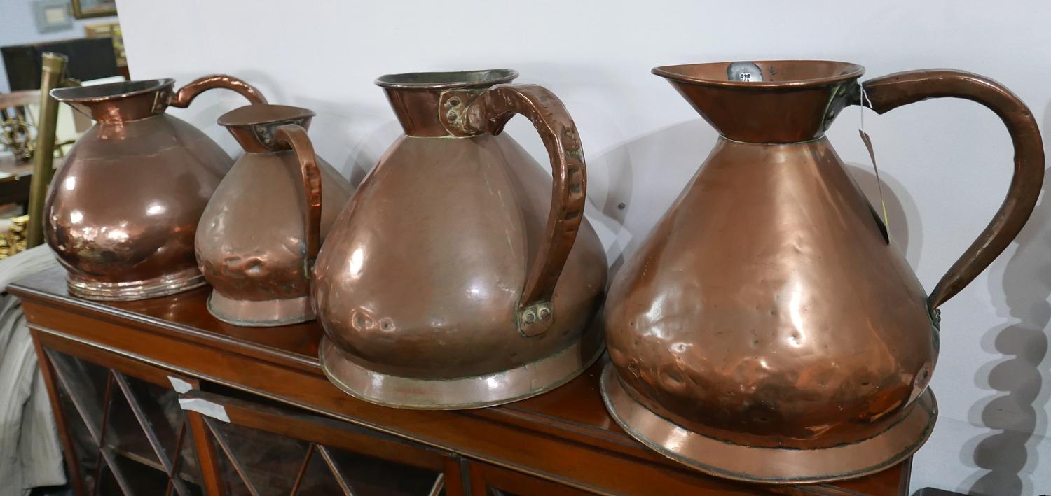 Four large copper flagons