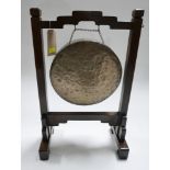 An Edwardian dinner gong on oak stand, no hammer, H.77 W.49cm