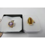 Two 9 ct yellow gold rings, one set with an oval-shaped tiger's eye cabochon Size L, 3g the other