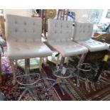 Three grey leather upholstered adjustable bar stools