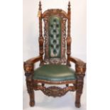 A large Indonesian carved teak throne chair. (damage to cresting rail and upholsterey) H.163cm