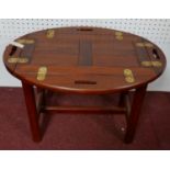A campaign style mahogany butler's tray/low table of small proportions, with hinged sides, H.47 W.96