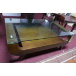 A contemporary teak coffee table with glass top, H.34 W.100 D.60cm