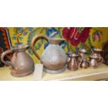 Eight copper jugs/flagons