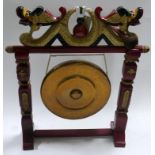 An early 20th century Chinese red lacquered dinner gong with hammer, H.83 W.75cm