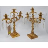 A pair of gilt metal three branch table lamps
