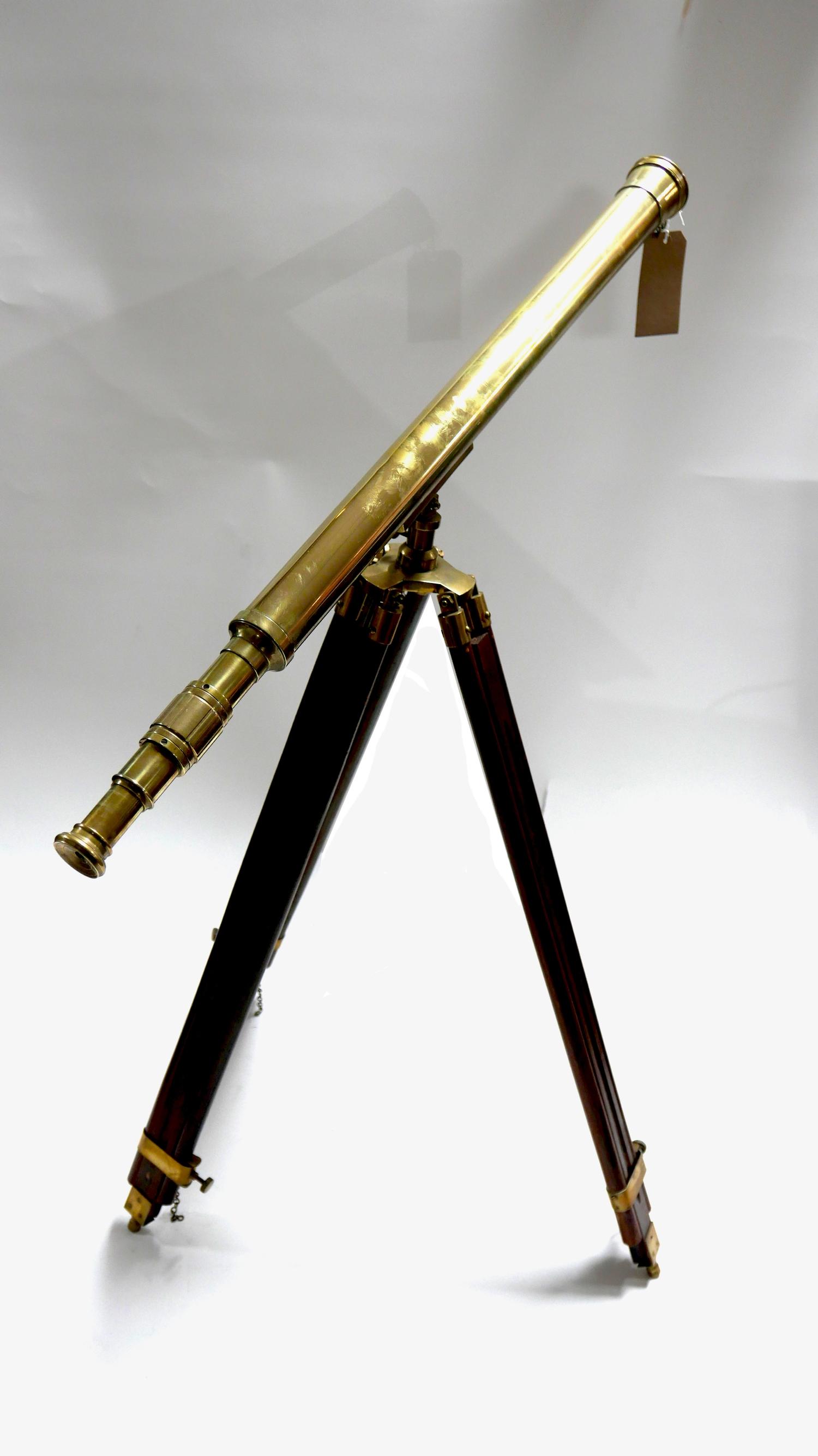 A vintage brass telescope on adjustable mahogany tripod stand