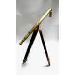 A vintage brass telescope on adjustable mahogany tripod stand