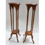 A pair of mahogany torcheres with spiral turned supports H.101cm