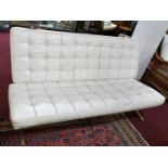 A Barcelona style settee in white leather upholstery, raised on chrome frame, L.155cm