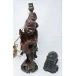 A Chinese carved hardwood lamp in the form of a robed sage standing on a craggy base, 40 x 10cm, and