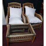 A pair of wicker framed conservatory armchairs, with feather cushions, together with a matching