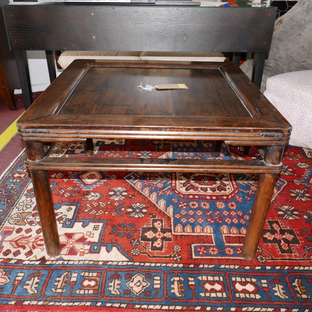 An early 20th century Chinese hardwood low table with a square-shaped top and ribbed side detailing,