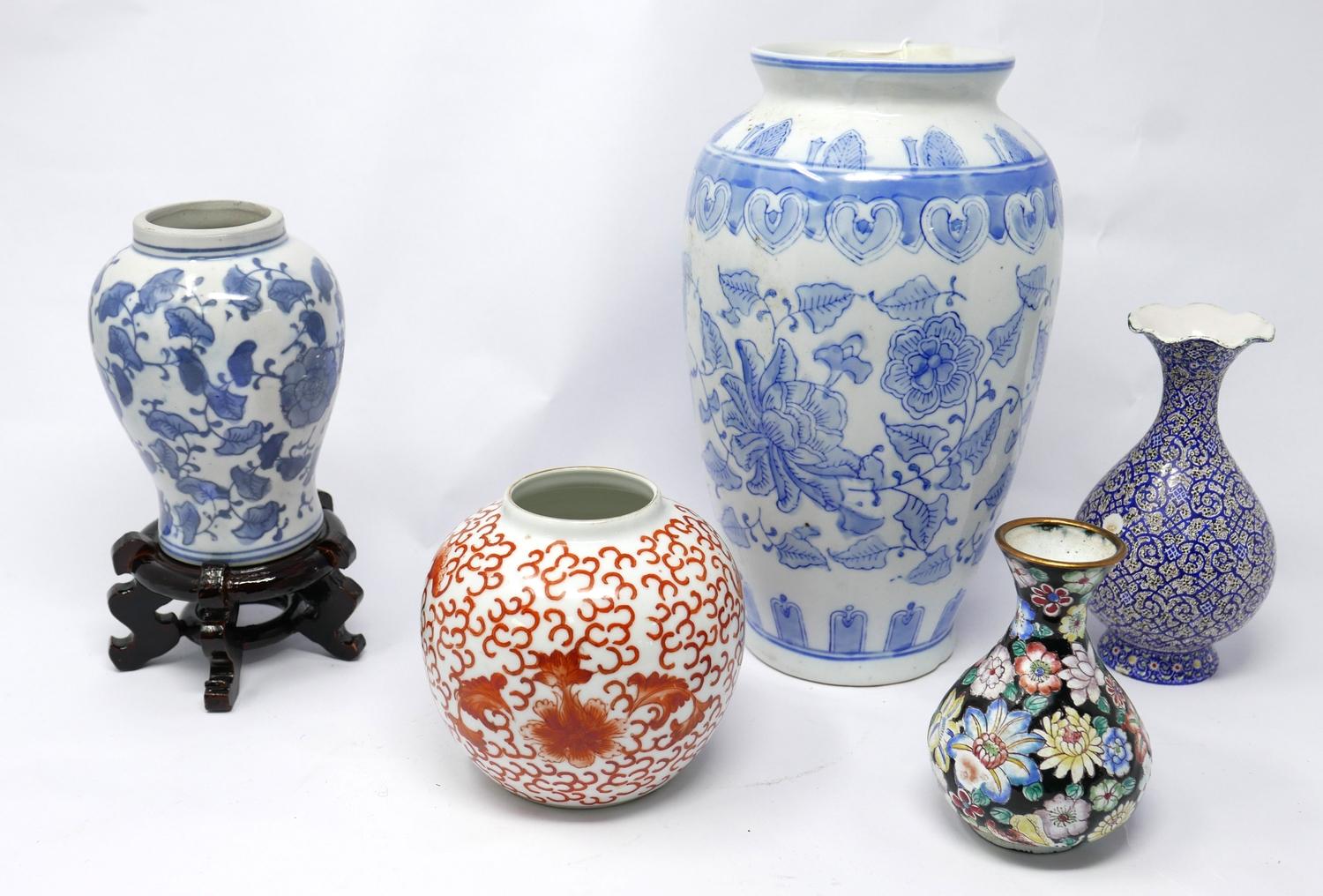 A collection of five vases to include three Chinese ceramic examples (one on a hardwood stand), a