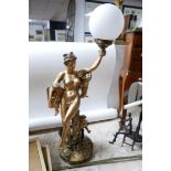 A gilt table lamp, classical lady holding a globe H.72cm