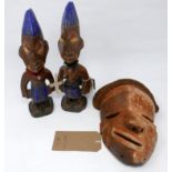 A pair of Yoruba Ibeji twin figures, together with an African Pende tribal carved wooden and hessian