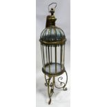 A pair of contemporary gilt metal storm lanterns, raised on tri-form stands, H.110cm (2)