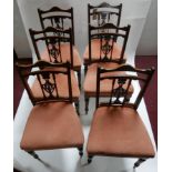 A set of six Edwardian mahogany dining chairs with pink velour upholstered seats