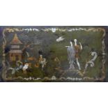 A Chinese incised and gilt painted panel depicting figures in a woodland with a pagoda, 35 x 66cm