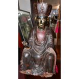 A large 19th century Chinese-Tibetan carved wood and gesso seated figure, possibly depicting the