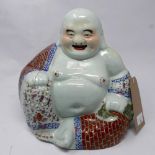 A late 19th century Chinese Republic porcelain model of a seated Buddha, H.26cm (badly restored)