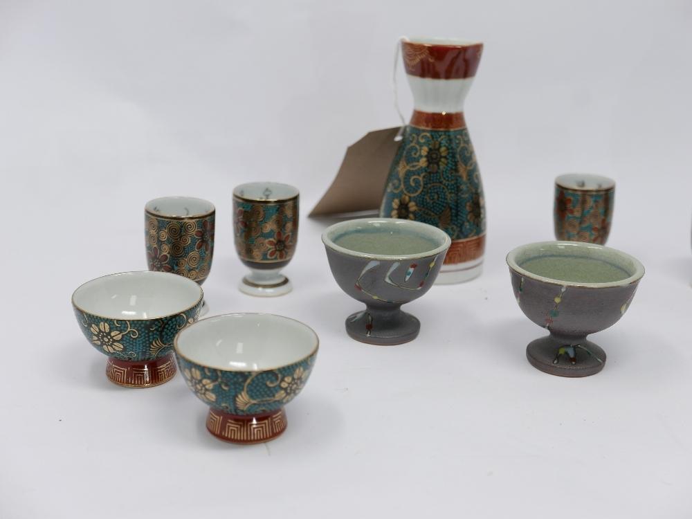 Two Japanese sake jars and a collection of sake cups - Image 2 of 3