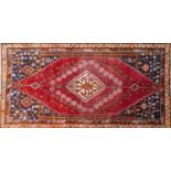 A South West Persian Qashqai rug, central diamond medallion with repeating petal motifs on a