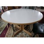 A Gordon Russell breakfast table with white laminate top with pillar support and x-frame base, H.